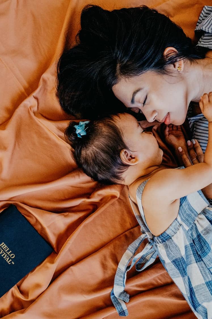 Mother cuddling with child